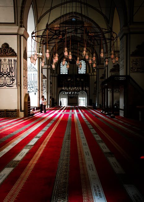 pexels-photo-6077486-6077486 Beautiful interior of a mosque with vibrant red carpet and intricate chandeliers. Perfect for interior design inspiration.